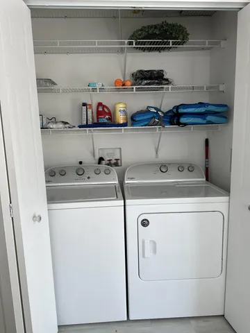 a view of a patio with dining table and chairs with wooden floor