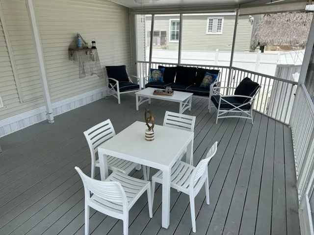 a dining room with wooden floor glass table and chairs