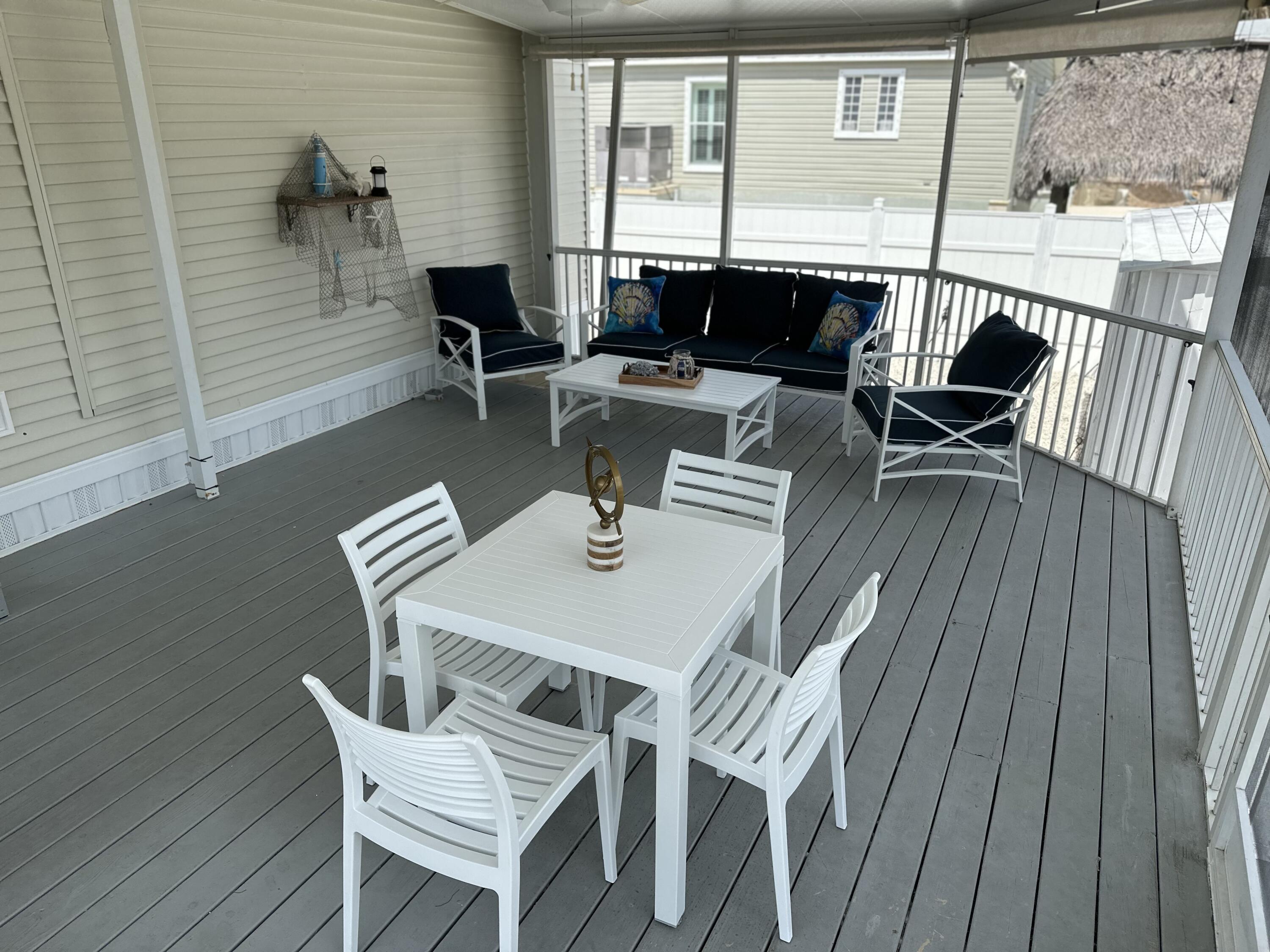 240 Taylor Drive Key Largo, FL 33037 - Photo 19 of 25 a view of a dining room with furniture and wooden floor