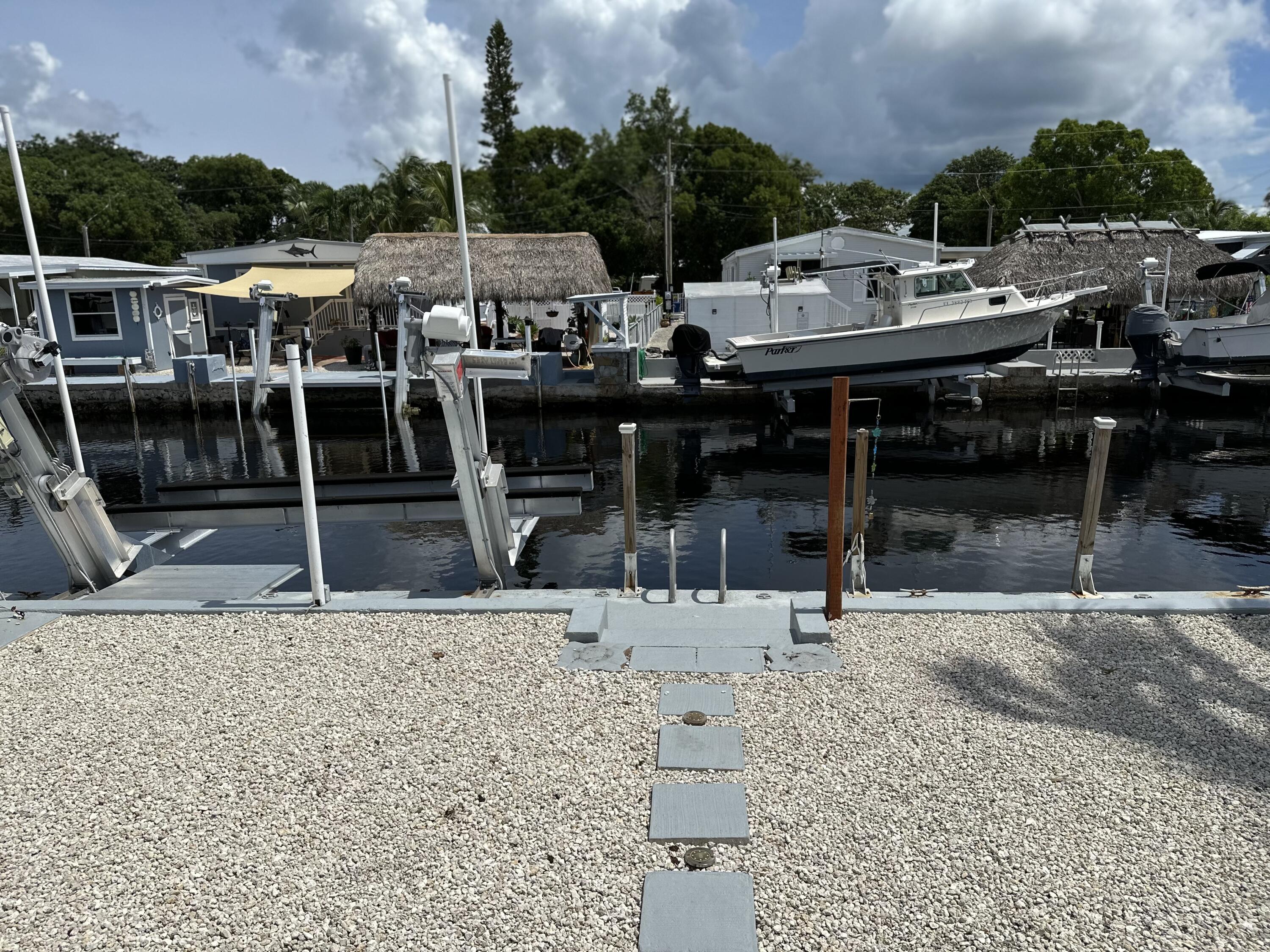 240 Taylor Drive Key Largo, FL 33037 - Photo 21 of 25 a view of a patio with a table and chairs
