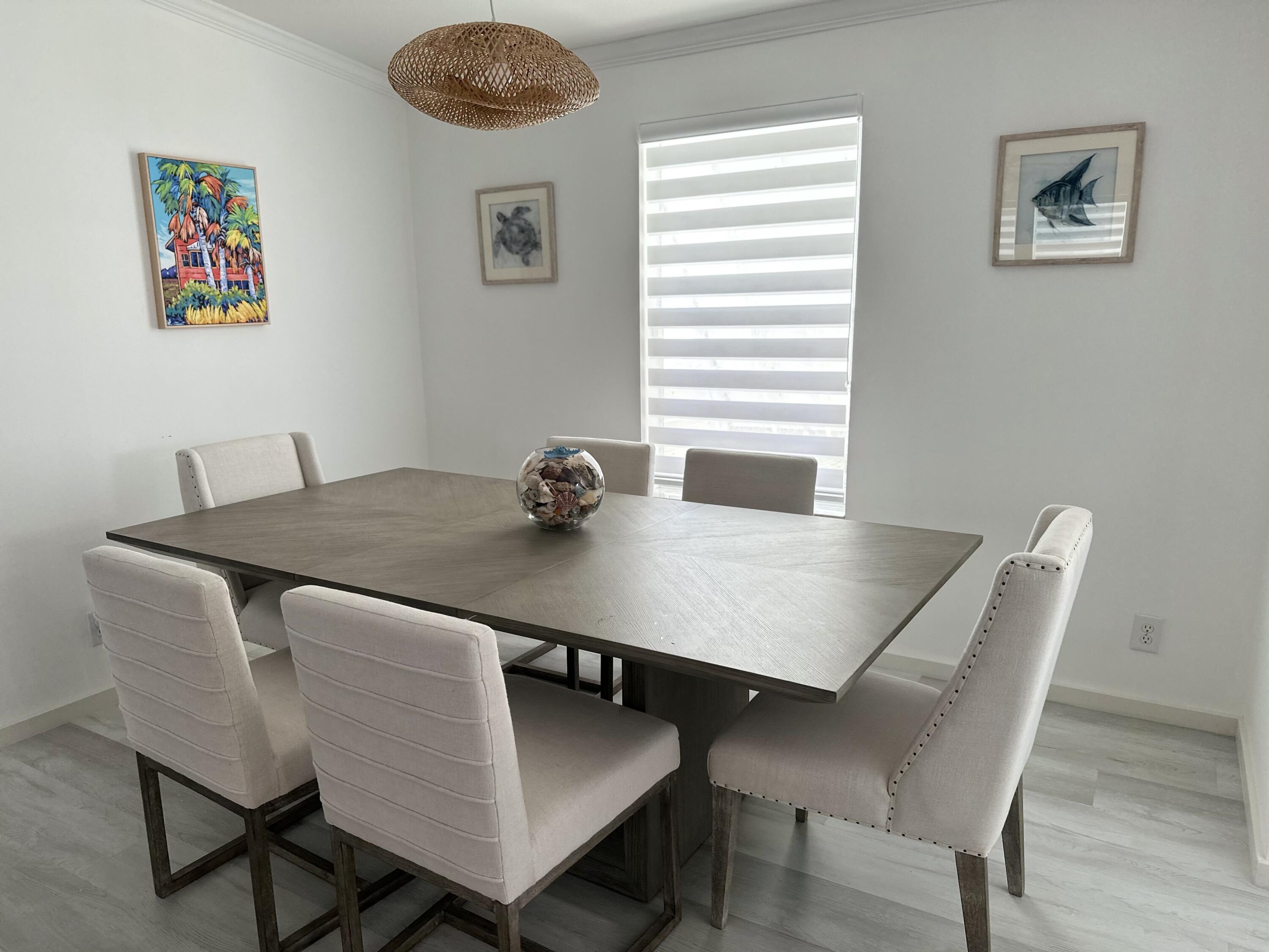 240 Taylor Drive Key Largo, FL 33037 - Photo 7 of 25 a view of a dining room with furniture and wooden floor