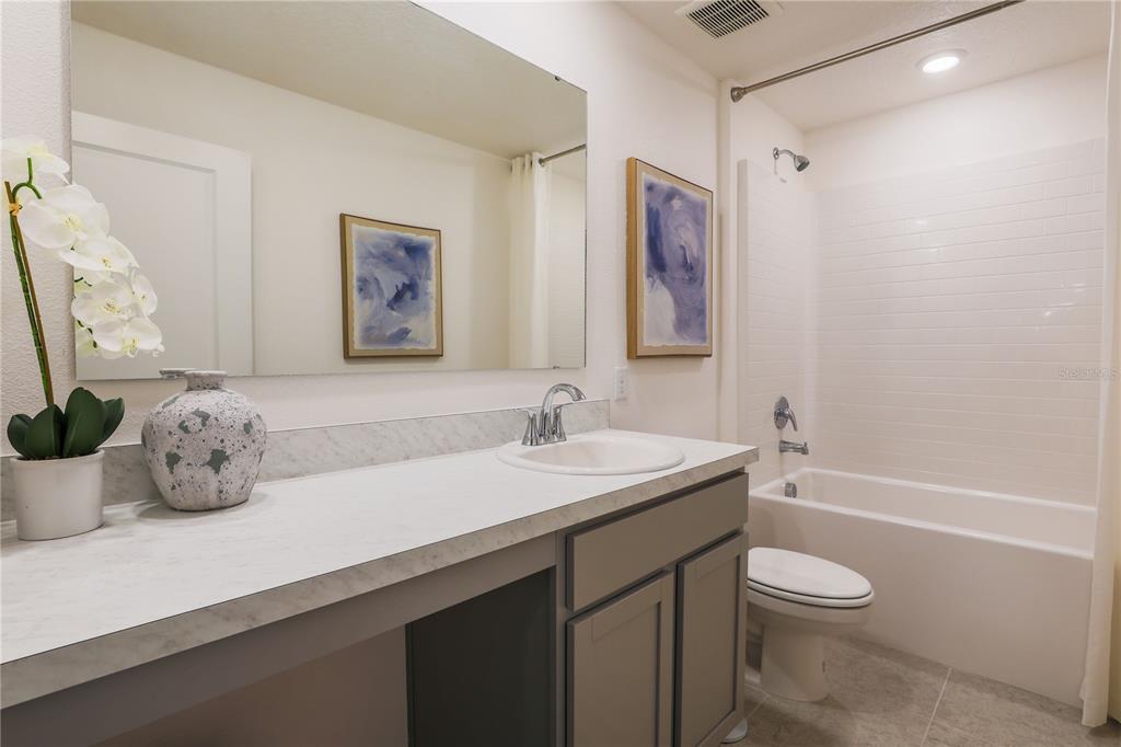 12 Hemlock Cir Way Ocala, FL 34472 - Photo 10 of 32 a bathroom with a granite countertop sink a toilet and a bathtub
