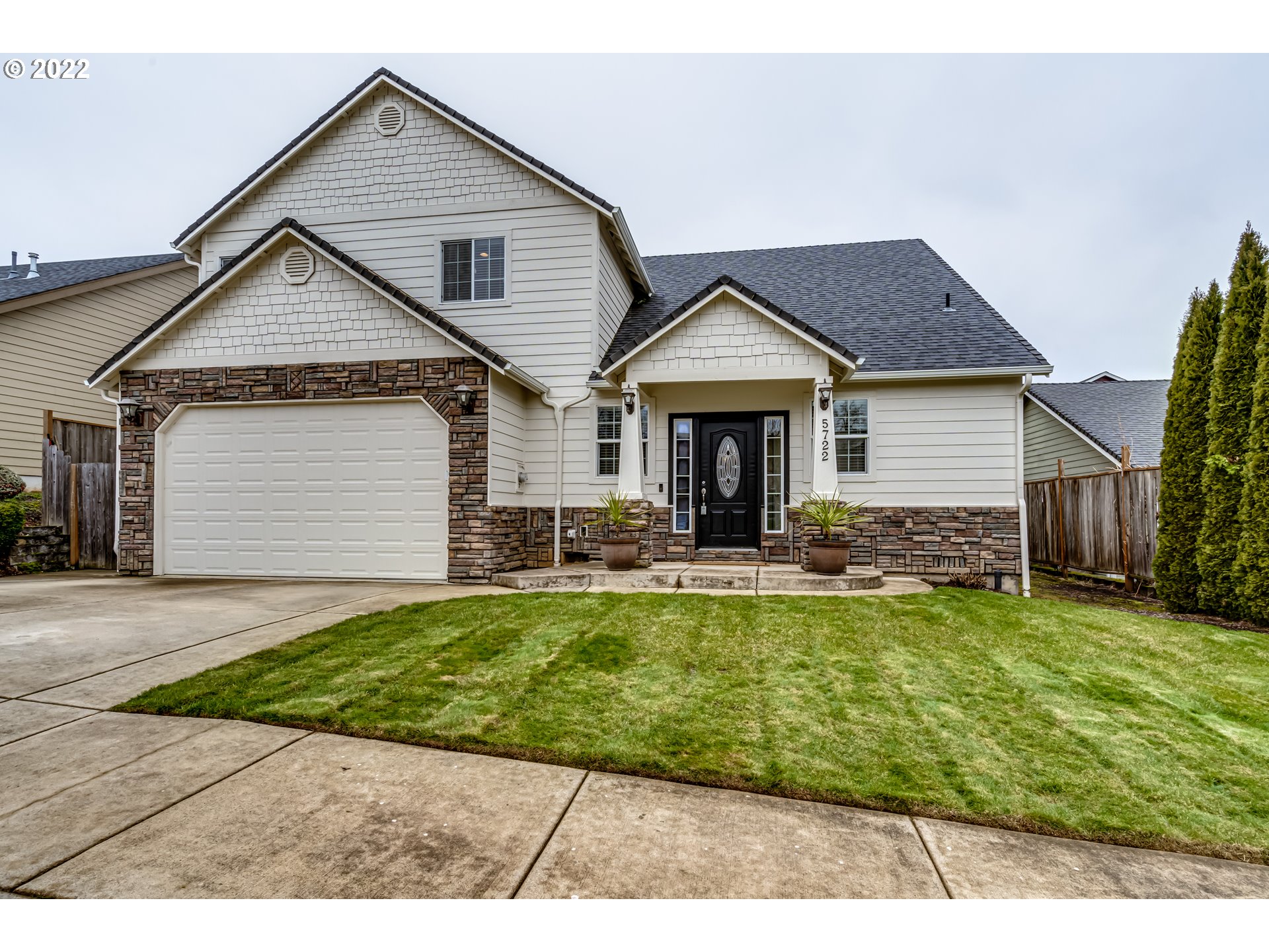 5722 Peridot Way Springfield, OR 97478 - Photo 1 of 27 a front view of a house with a yard and garage