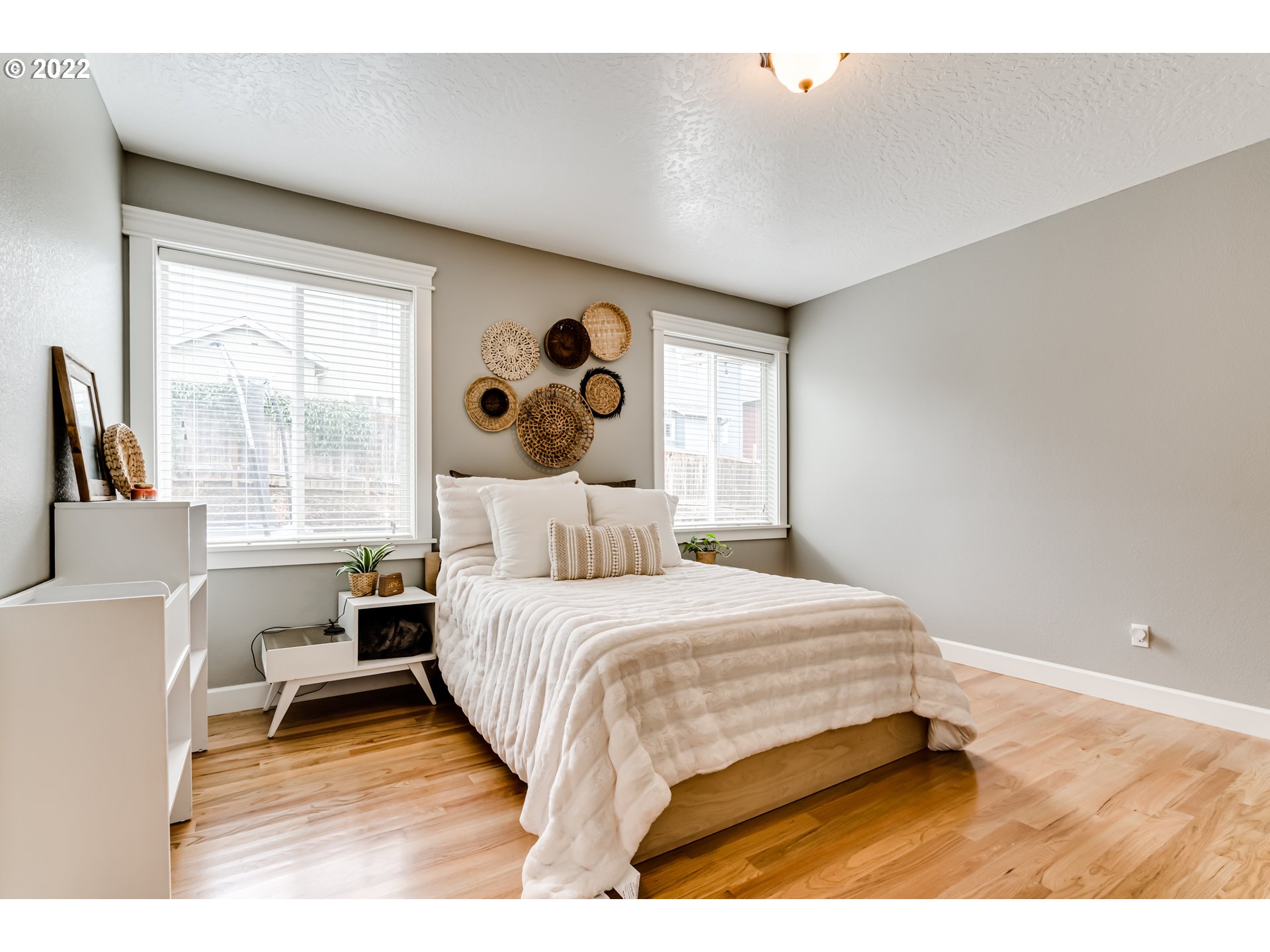 5722 Peridot Way Springfield, OR 97478 - Photo 12 of 27 a bedroom with a bed a table and a large window