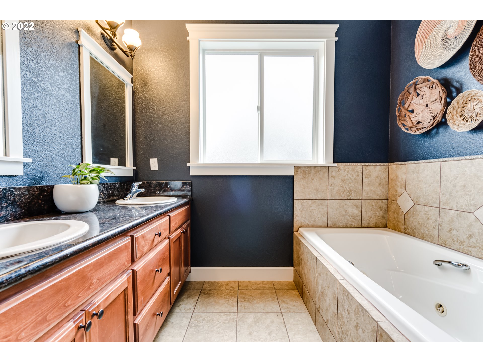 5722 Peridot Way Springfield, OR 97478 - Photo 13 of 27 a bathroom with a bathtub sink and a window