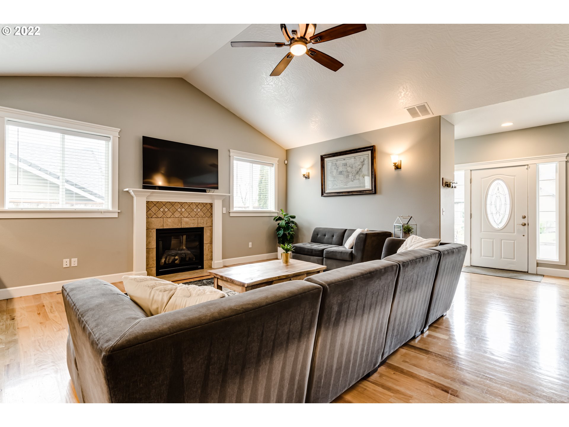 5722 Peridot Way Springfield, OR 97478 - Photo 5 of 27 a living room with furniture a fireplace and a flat screen tv