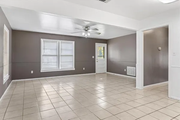 an empty room with windows and closet
