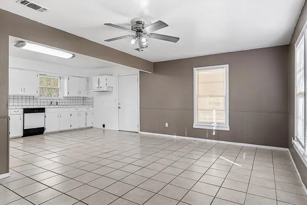 a view of an empty room with a kitchen