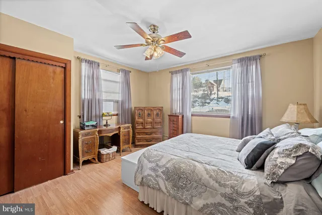 a spacious bedroom with a bed and a chandelier