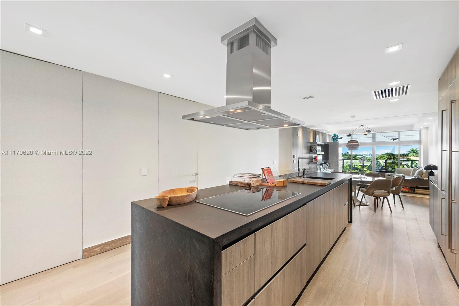 350 Ocean Drive, Unit 403N Key Biscayne, FL 33149 - Photo 12 of 55 a kitchen with a sink a stove and chairs