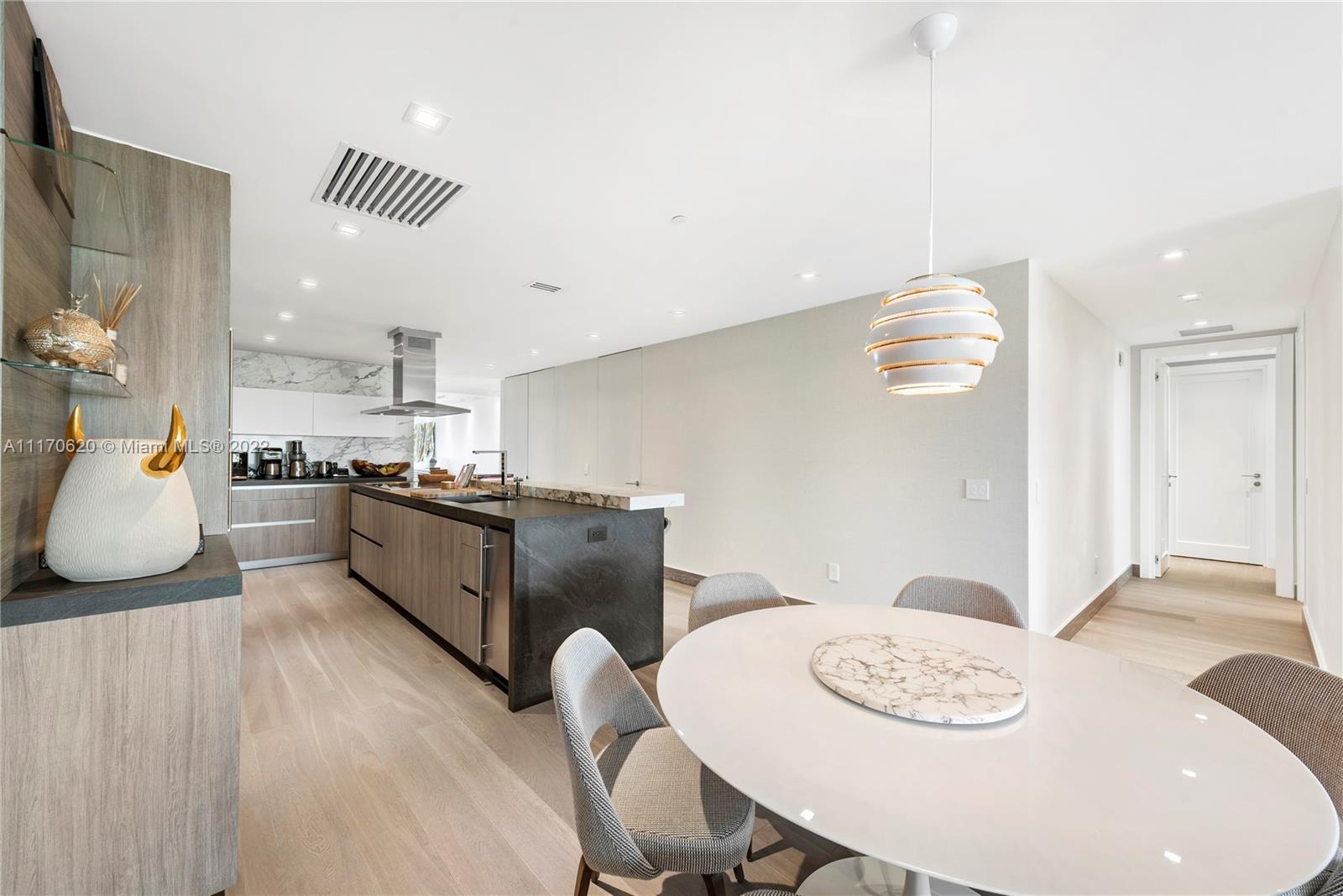 350 Ocean Drive, Unit 403N Key Biscayne, FL 33149 - Photo 14 of 55 a kitchen with stainless steel appliances granite countertop a stove a sink a dining table and chairs