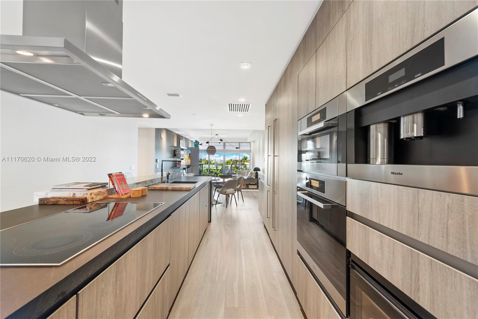 350 Ocean Drive, Unit 403N Key Biscayne, FL 33149 - Photo 15 of 55 a kitchen with stainless steel appliances granite countertop lots of counter top space a stove and wooden floor