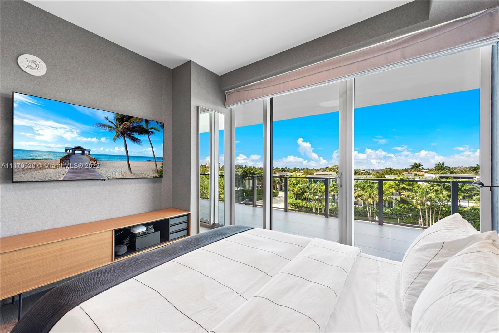 350 Ocean Drive, Unit 403N Key Biscayne, FL 33149 - Photo 34 of 55 a bedroom with a large bed and a balcony view