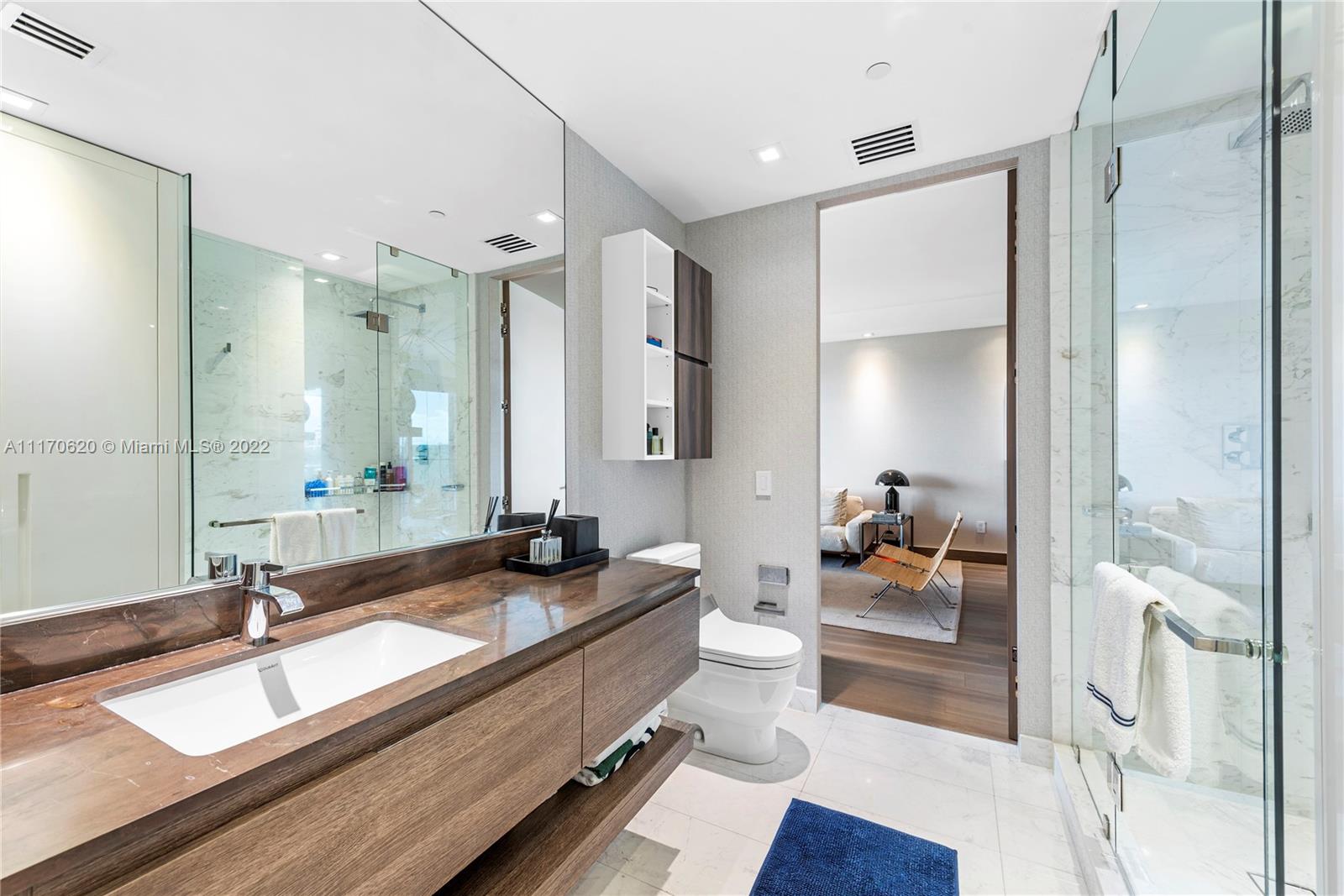 350 Ocean Drive, Unit 403N Key Biscayne, FL 33149 - Photo 35 of 55 a large bathroom with double vanity sinks a mirror and a shower