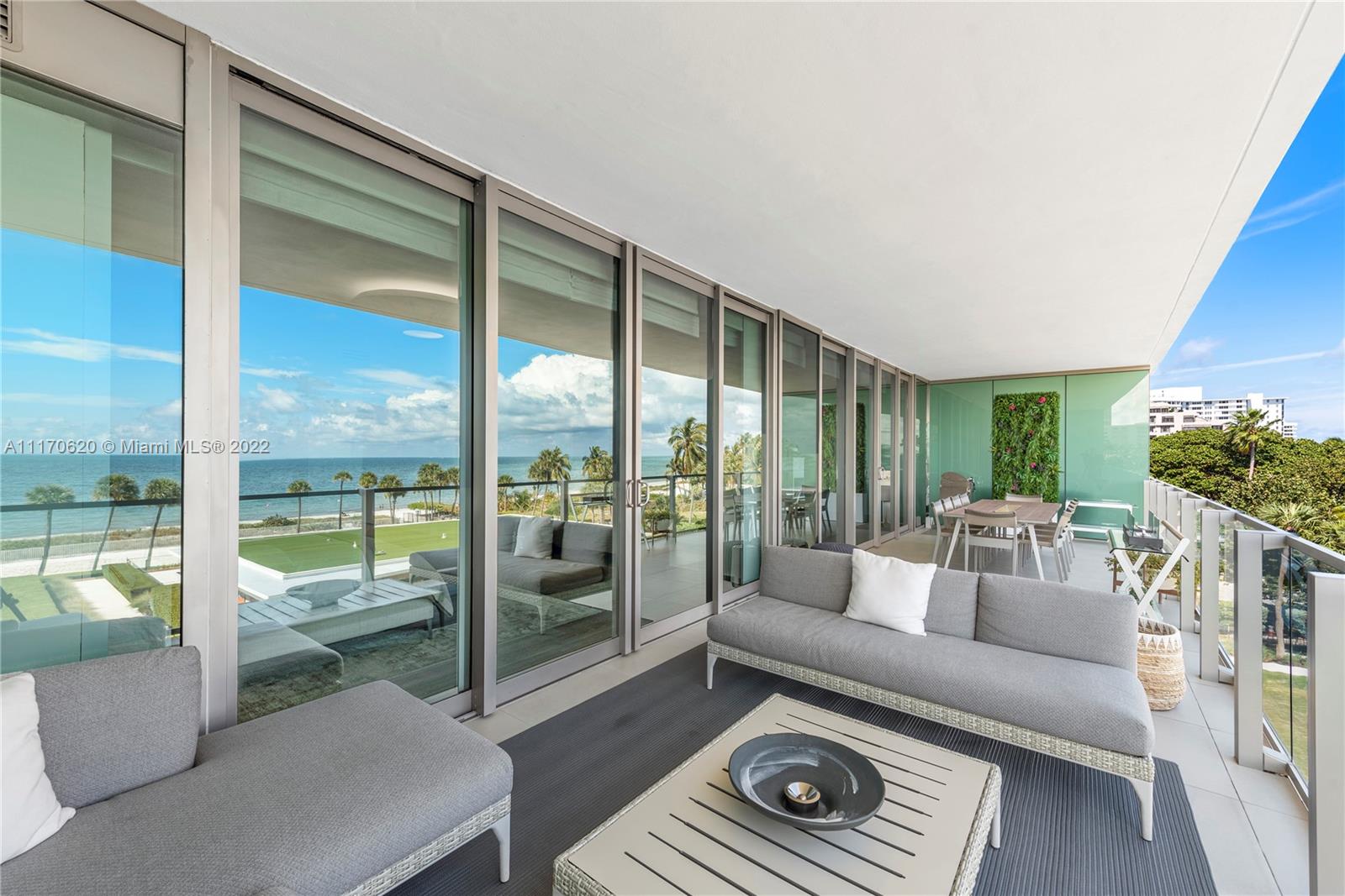 350 Ocean Drive, Unit 403N Key Biscayne, FL 33149 - Photo 40 of 55 a living room with furniture and a floor to ceiling window