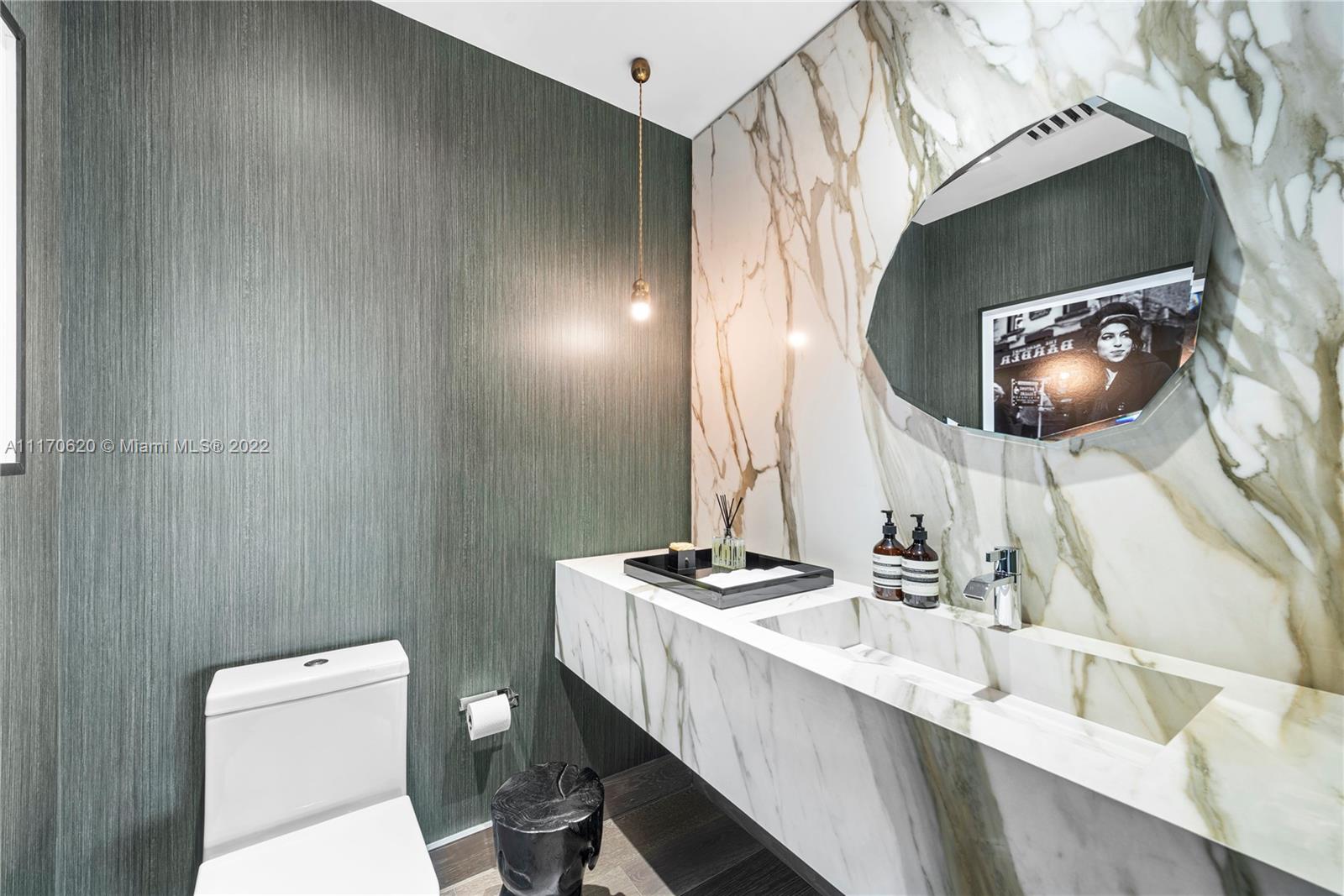 350 Ocean Drive, Unit 403N Key Biscayne, FL 33149 - Photo 10 of 55 a bathroom with a sink a toilet and mirror