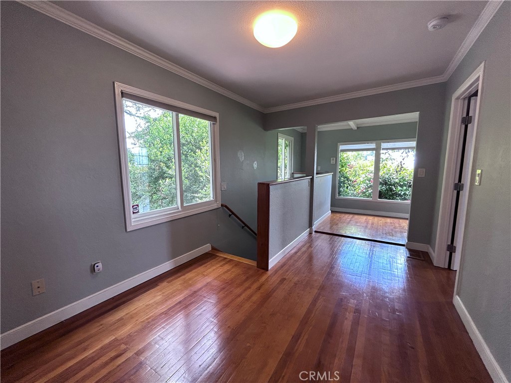 1009 Keith Avenue Berkeley, CA 94708 - Photo 30 of 36 an empty room with wooden floor and windows