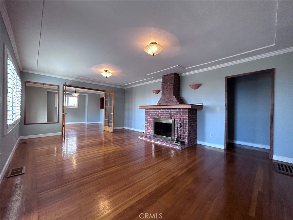 1009 Keith Avenue Berkeley, CA 94708 - Photo 9 of 36 a view of empty room with wooden floor and fireplace