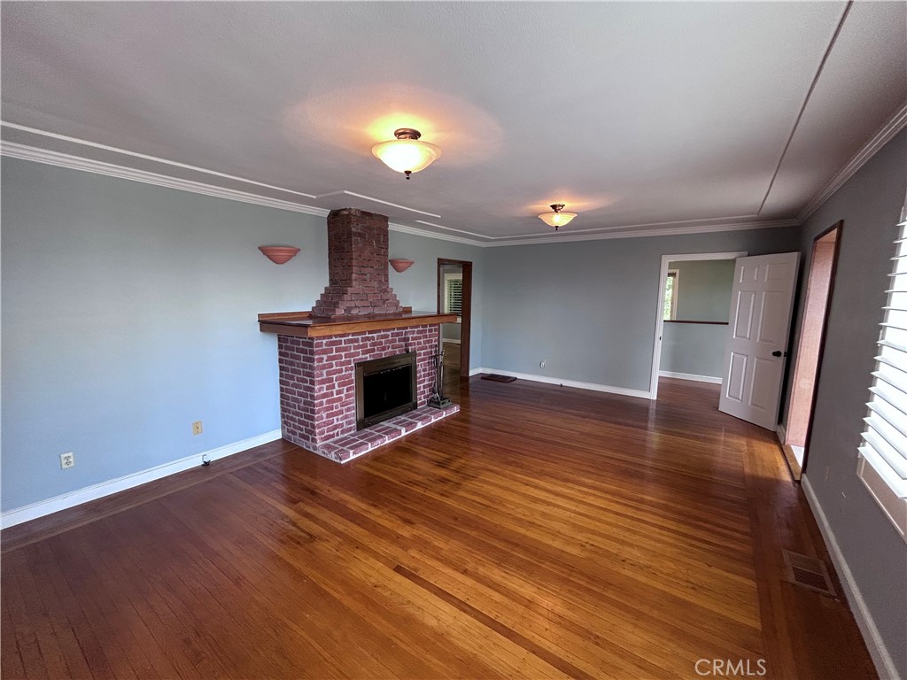 1009 Keith Avenue Berkeley, CA 94708 - Photo 10 of 36 a view of empty room with wooden floor and fireplace