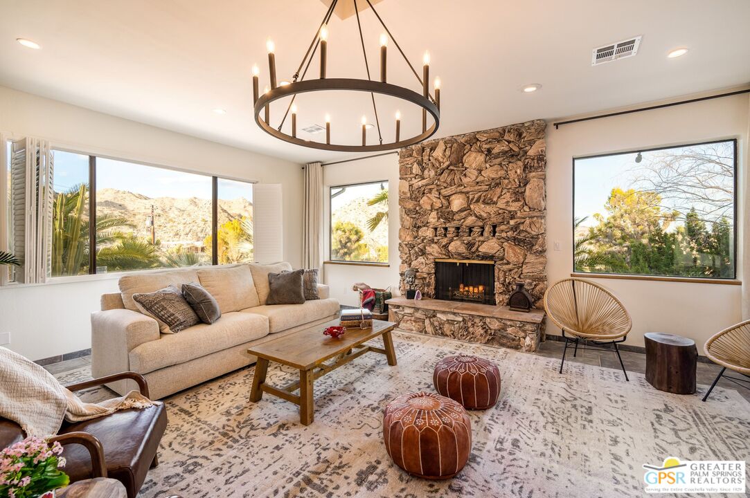 54045 Ridge Road Yucca Valley, CA 92284 - Photo 3 of 46 a living room with furniture a fireplace and a large window