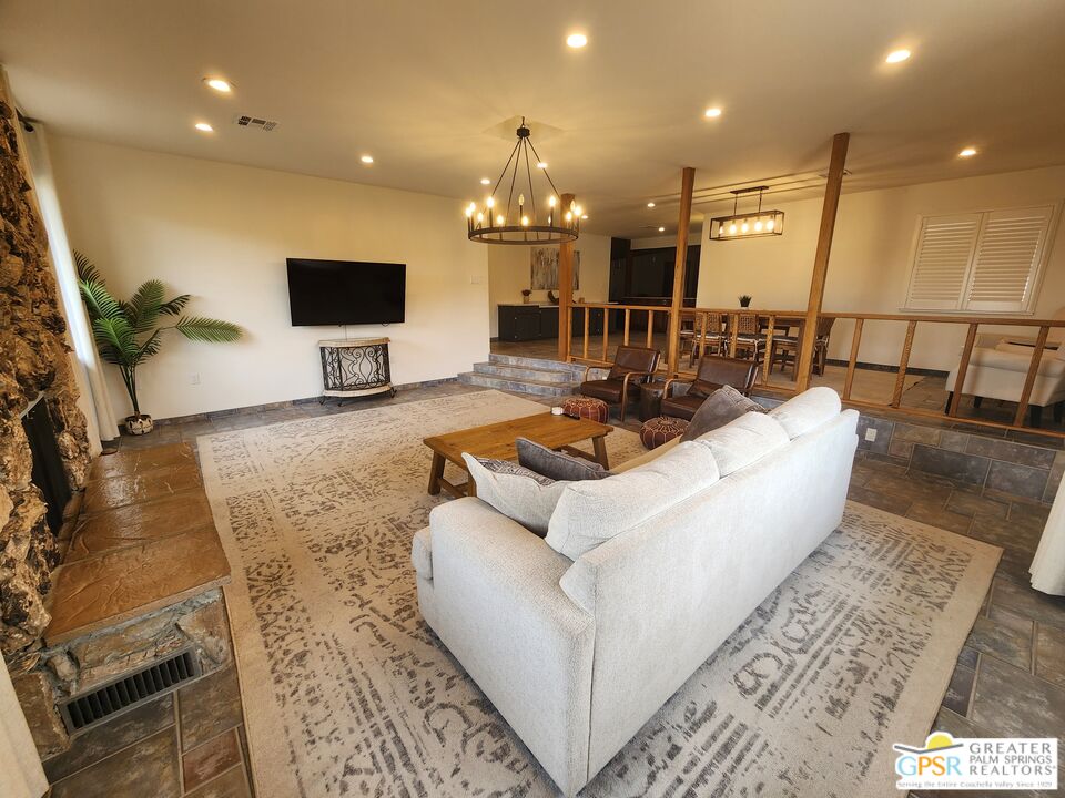 54045 Ridge Road Yucca Valley, CA 92284 - Photo 9 of 46 a living room with furniture and a flat screen tv