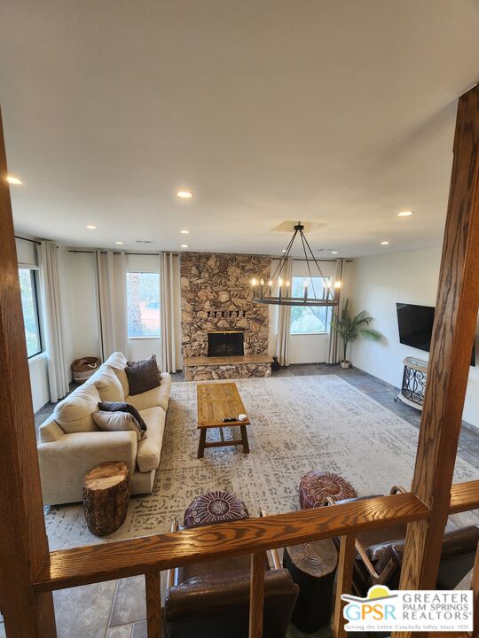 54045 Ridge Road Yucca Valley, CA 92284 - Photo 10 of 46 a living room with furniture and a fireplace