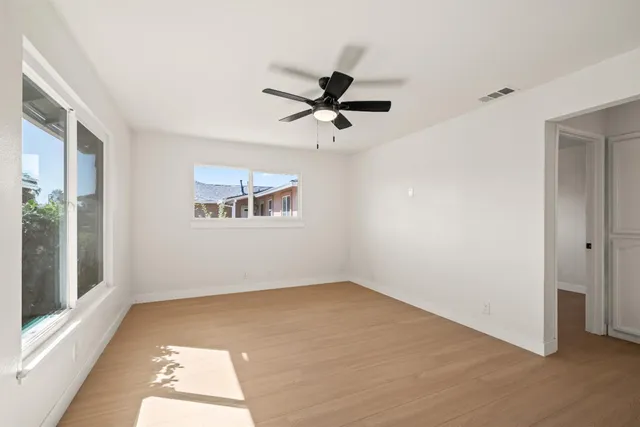 wooden floor in an empty room with a window