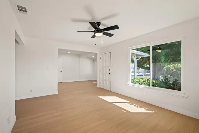 a view of a livingroom with a ceiling fan and window