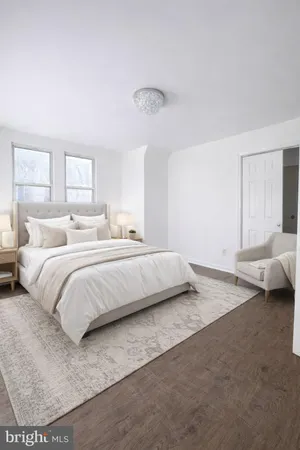 a bedroom with a bed and a night stand