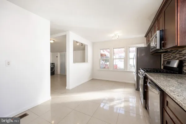 a view of a kitchen cabinets and a stove
