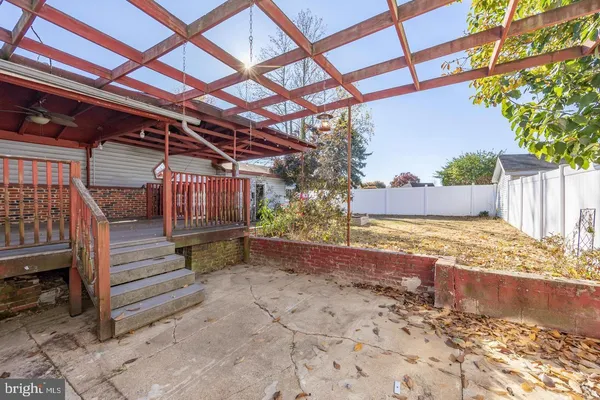 a view of backyard with wooden fence
