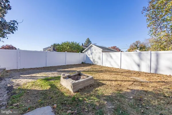 a view of a backyard with table and chairs