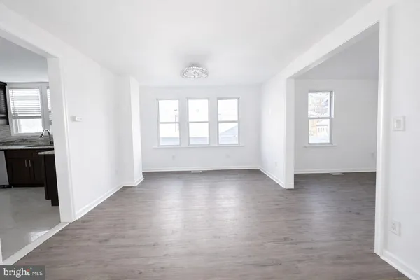 an empty room with windows and closet