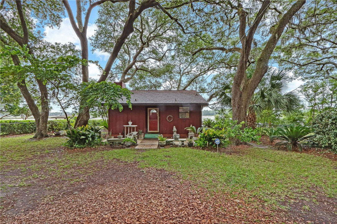 96270 Willyoung Road Yulee, FL 32097 - Photo 1 of 9 a front view of a house with a yard and an trees