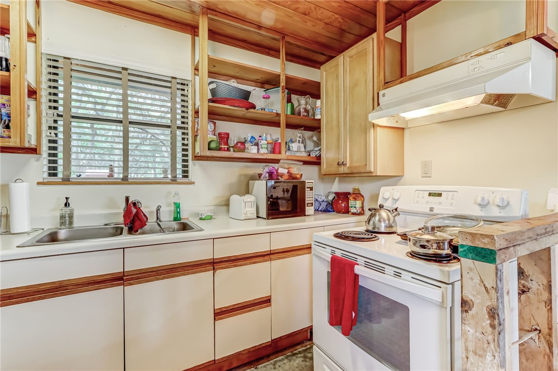 96270 Willyoung Road Yulee, FL 32097 - Photo 5 of 9 a kitchen with stainless steel appliances a sink stove and cabinets