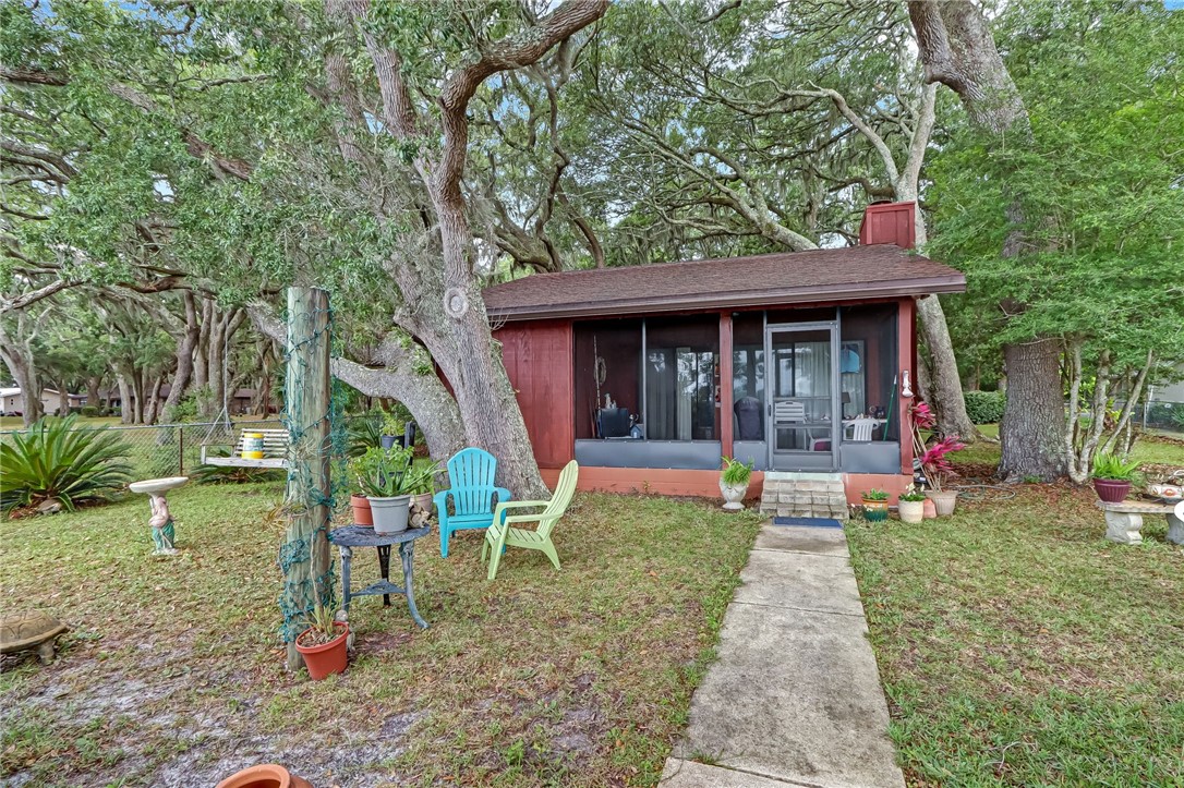 96270 Willyoung Road Yulee, FL 32097 - Photo 9 of 9 a view of a chair and table in backyard of the house