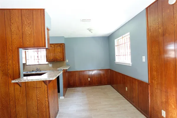 a kitchen with a sink wooden floor and a window