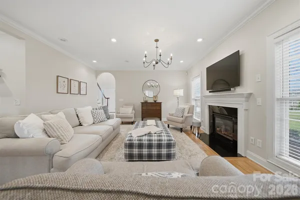 a kitchen with stainless steel appliances granite countertop a stove a sink dishwasher a refrigerator and a oven with wooden floors