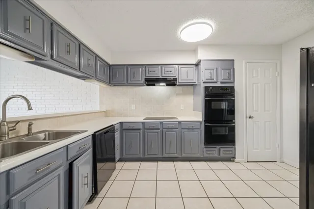 a kitchen with stainless steel appliances granite countertop a sink and cabinets