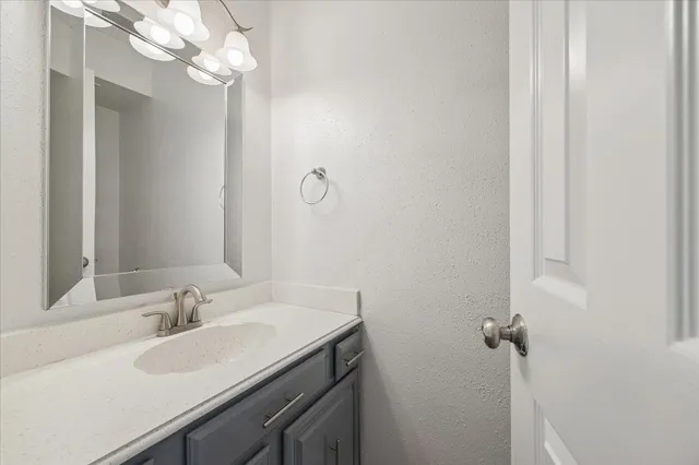 a bathroom with a sink vanity and a mirror