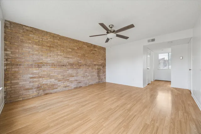 a view of an empty room and wooden floor