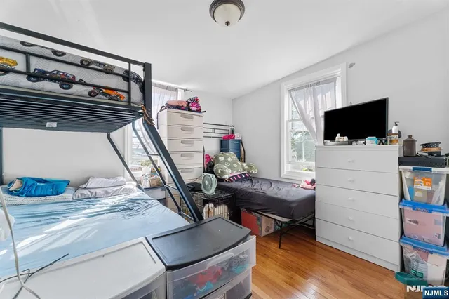 a bedroom with furniture and a flat screen tv