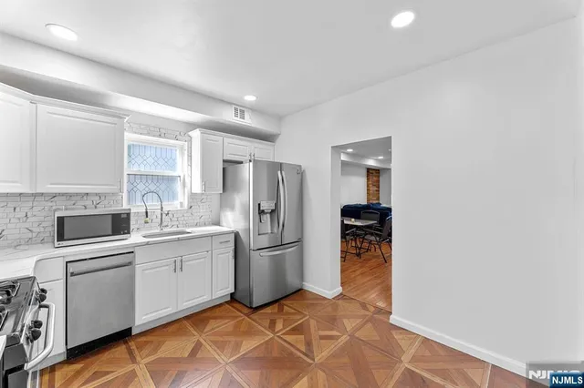 a kitchen with a sink cabinets and stainless steel appliances