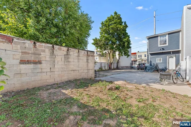 a view of a brick house with a yard