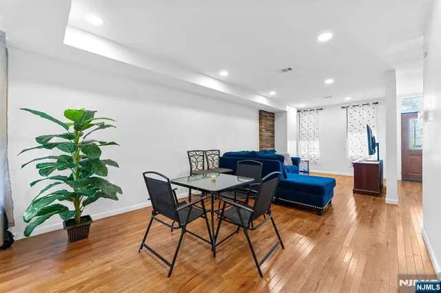 a view of a work space with furniture and wooden floor