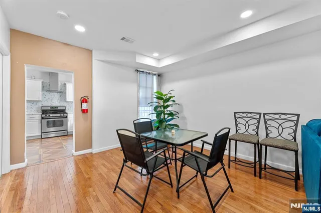 a view of a dining room with furniture and wooden floor