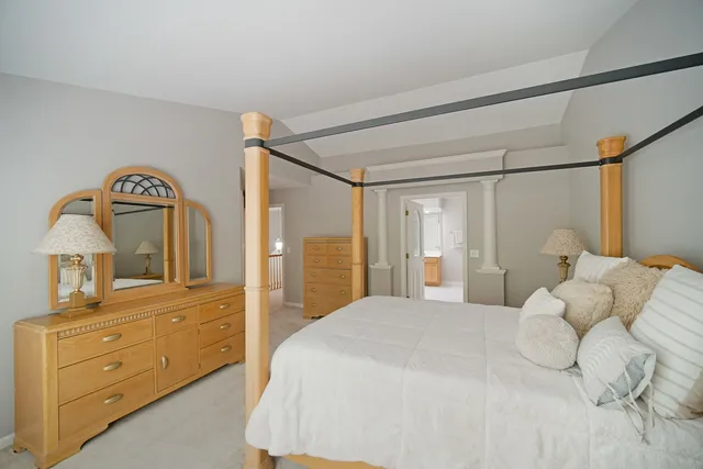 a bedroom with a bed and a dresser