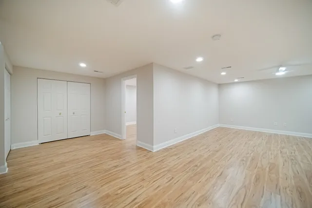 a view of an empty room with wooden floor