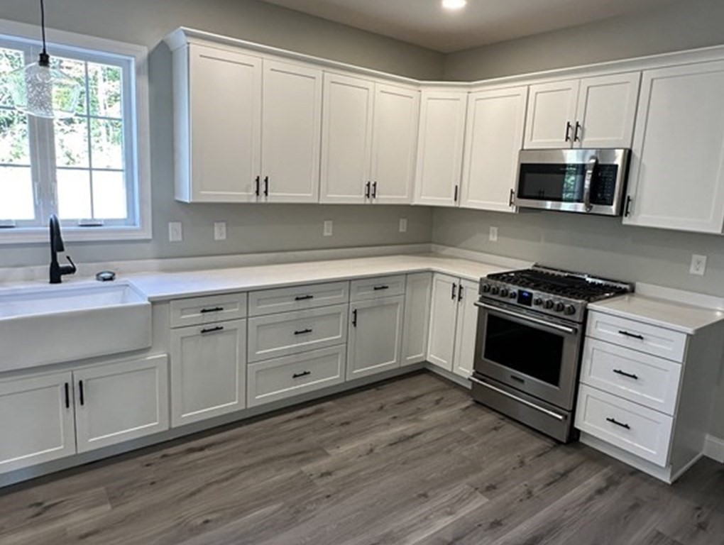 38 Juniper Road Ashburnham, MA 01430 - Photo 14 of 19 a kitchen with white cabinets white stainless steel appliances and sink