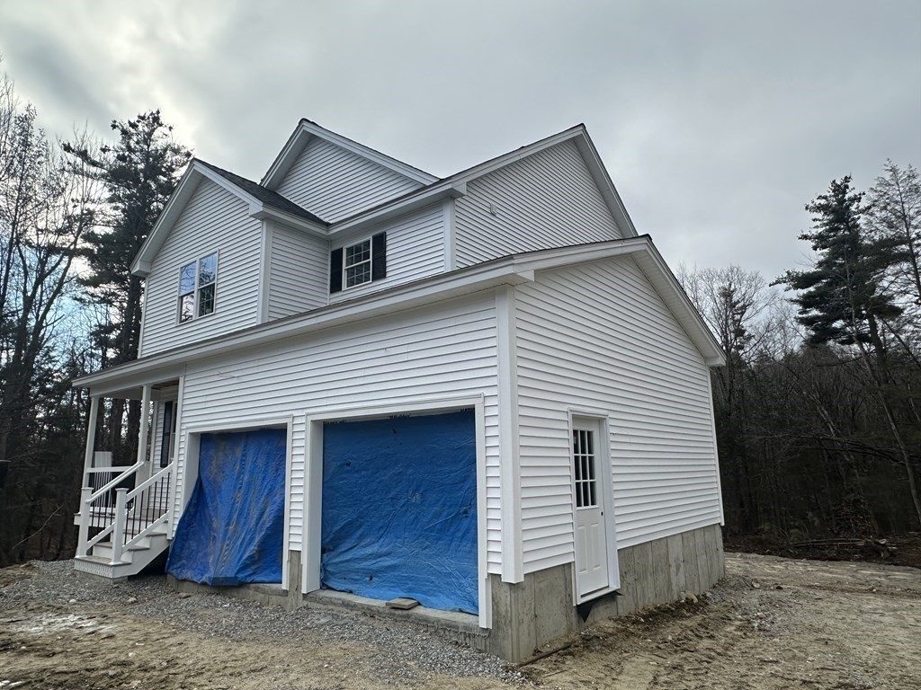 38 Juniper Road Ashburnham, MA 01430 - Photo 5 of 19 a view of a house with a yard and garage